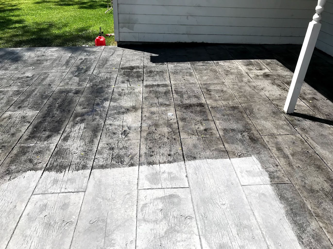 Faded stamped concrete patio in Cypress needing professional resealing